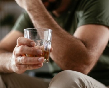 Professional pouring a drink at home after work