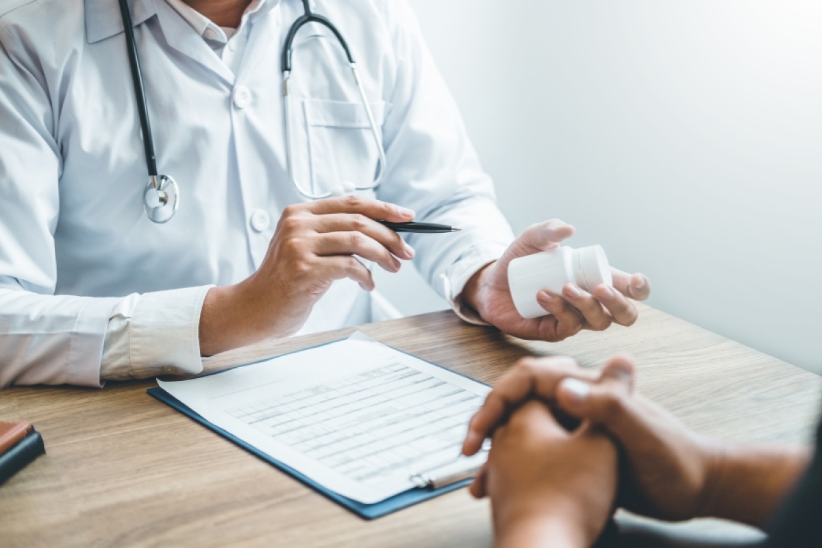 Doctor explaining alcohol implant treatment to a patient during a consultation