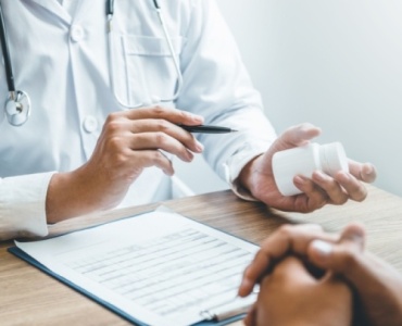 Doctor explaining alcohol implant treatment to a patient during a consultation